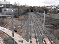 Metrolink construction at Werneth, 4 March 2012:      viewed from  Featherstall Road  the newly laid track heads into the Werneth Tunnel towards Mumps.  On the left the concrete track bed for a later tram route has been laid.